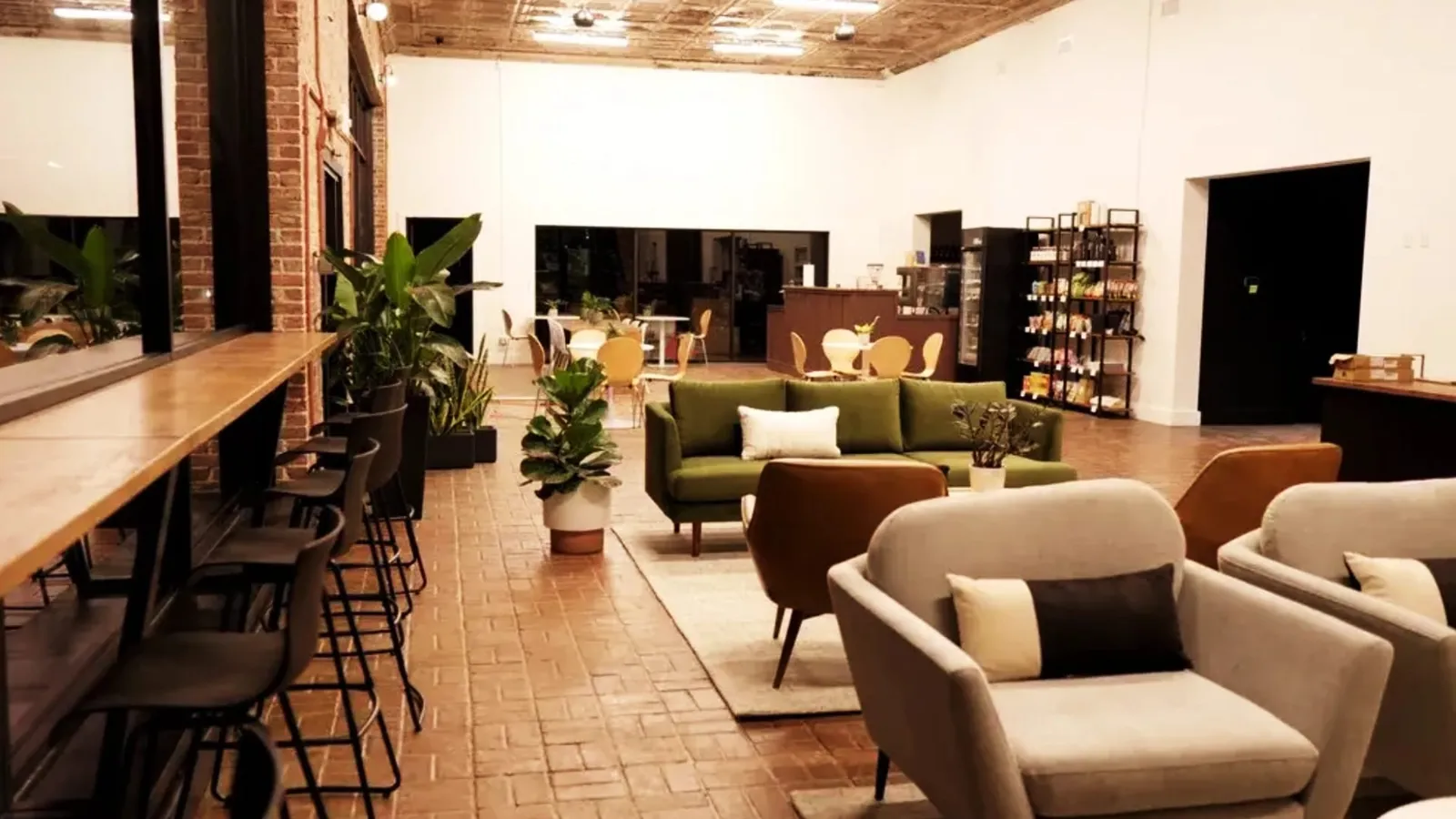 The lounge at the Co-Create Innovation Hub in Russellville, with couches, armchairs and a long work counter